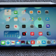 The 6th generation Apple iPad Mini sitting on a cushion with the Apple Pencil attached to its top edge.